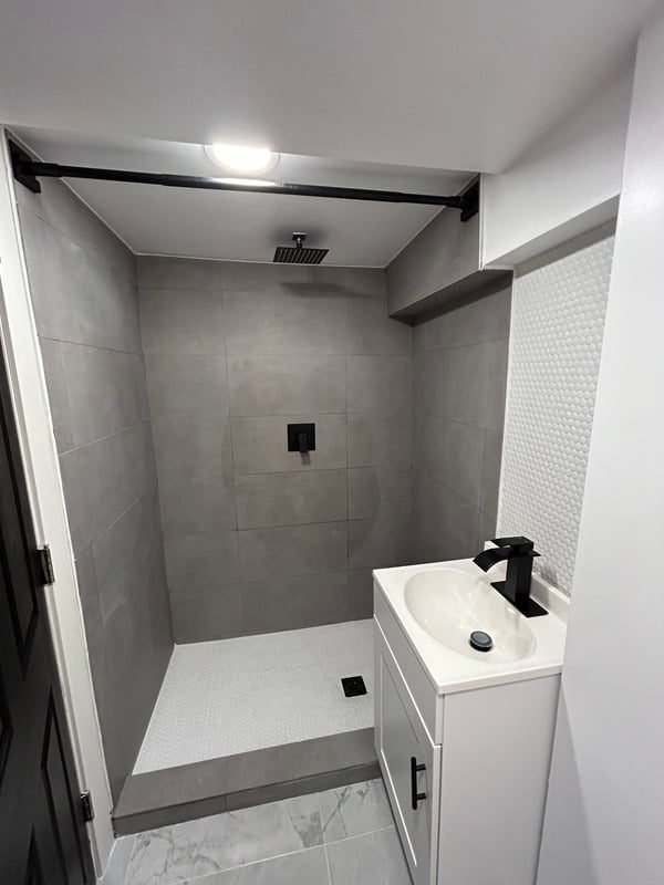 New basement bathroom with walk-in tile shower