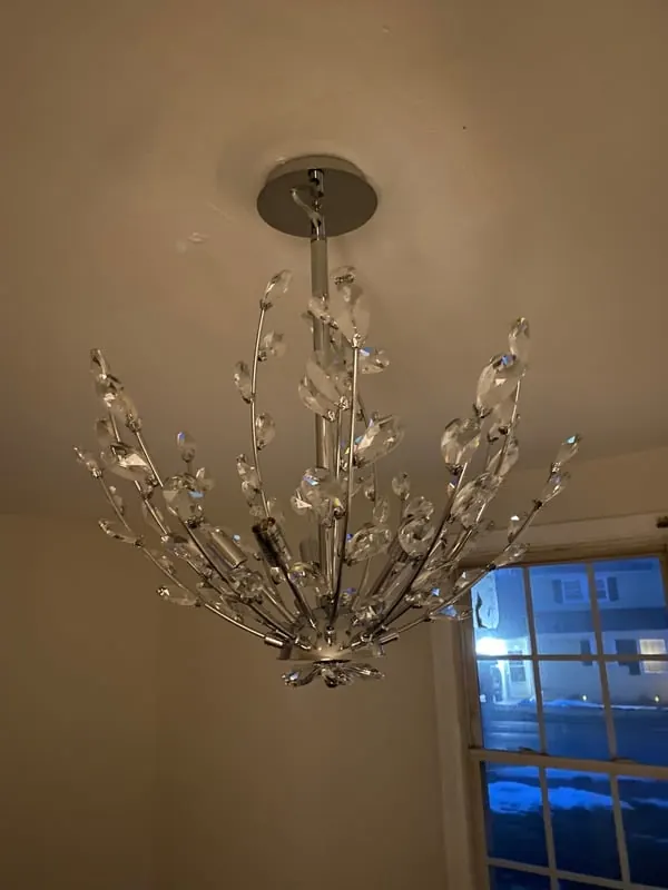Crystal chandelier newly installed in a dining room