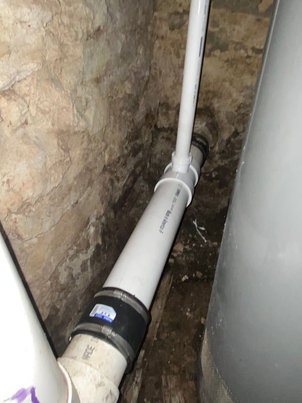 Basement plumbing repair with new PVC drain line